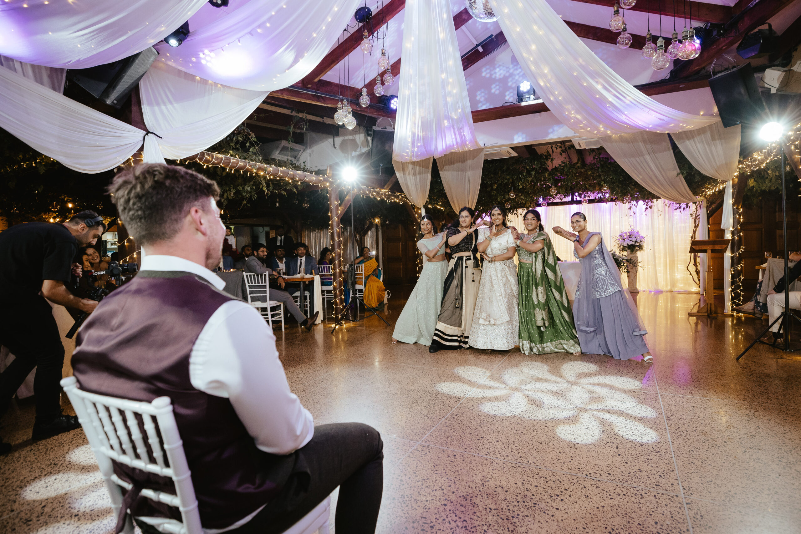 Groom watching a wedding dance performance