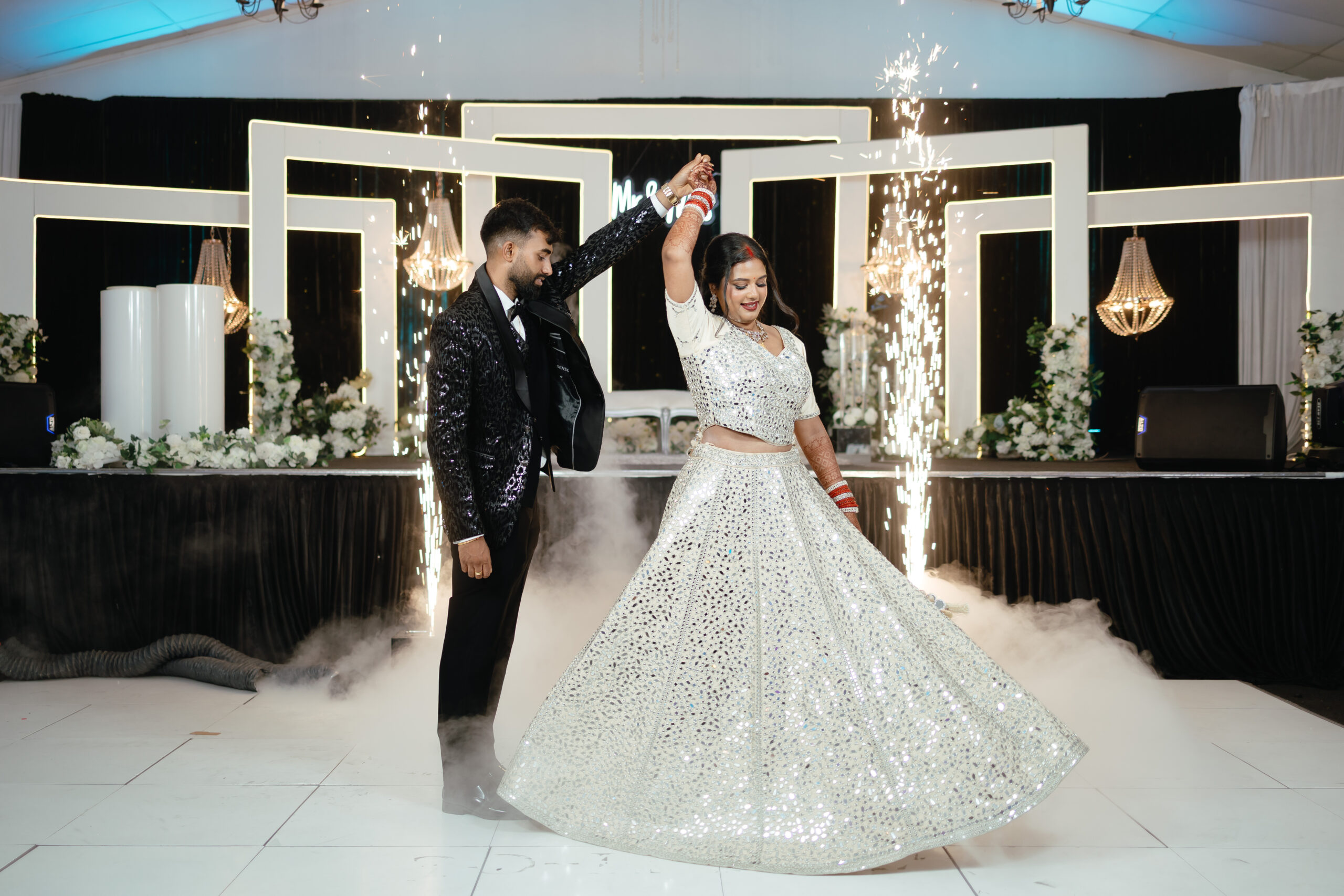 Couple dancing under sparklers at their Sangeet Night wedding