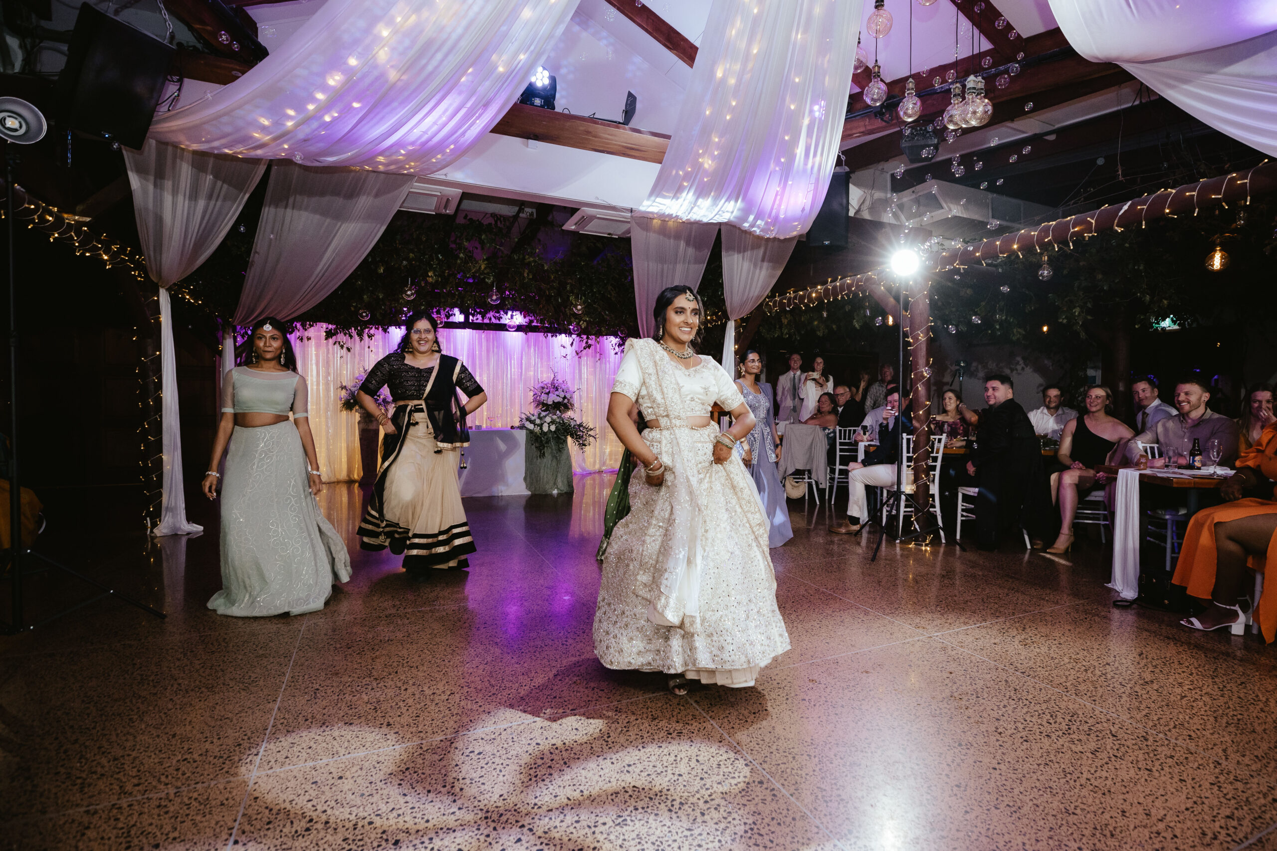 Bride dancing with bridesmaids at a wedding reception
