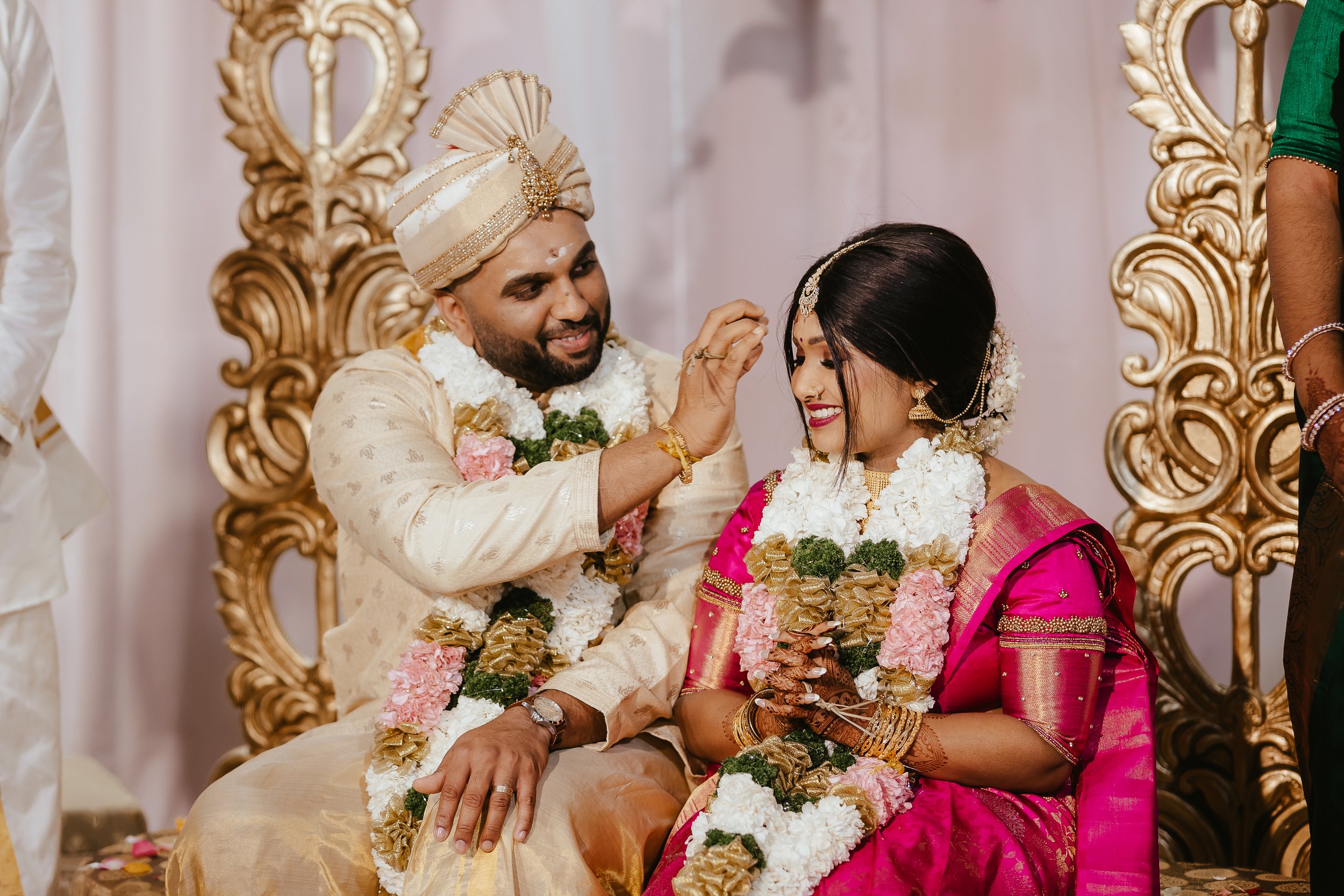 Indian wedding couple sharing a joyful moment during their traditional ceremony