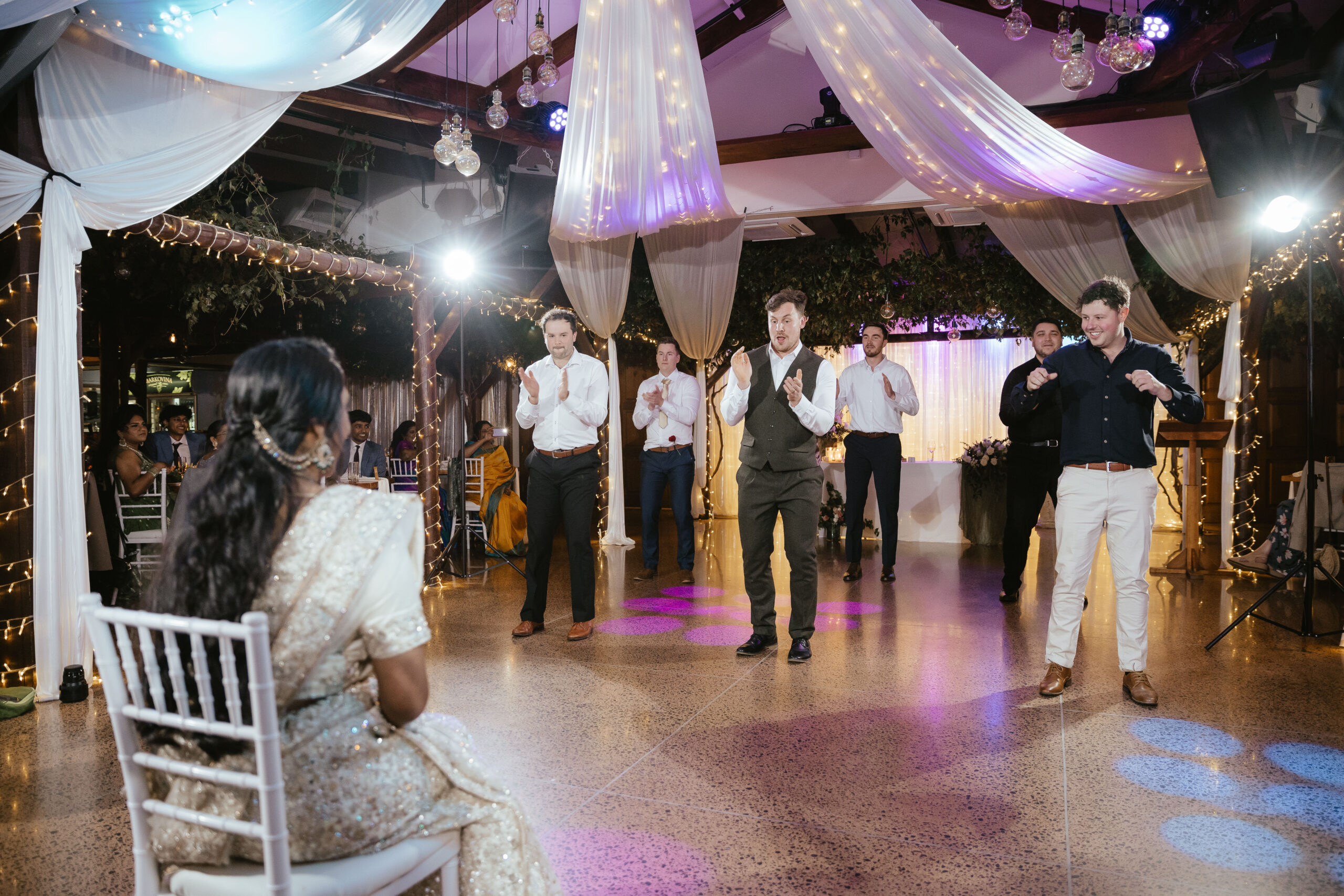 Wedding guests dancing at an indoor reception